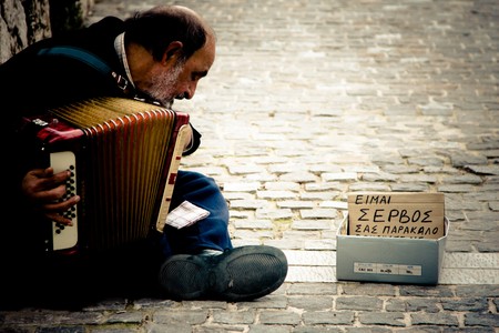 ATHENS, GREECE - FEBRUARY 04: Old serbian immigrant playing an accordion in downtown on February 04, 2010 in Athens, Greece.のeditorial素材