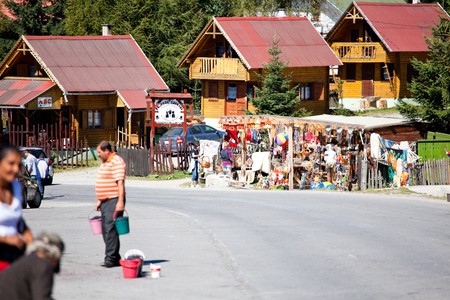 BUCIN PASS, ROMANIA - AUGUST 21: Poor people selling berries to tourists in Bucin Pass on August 21, 2010 in Harghita County, Romania.のeditorial素材