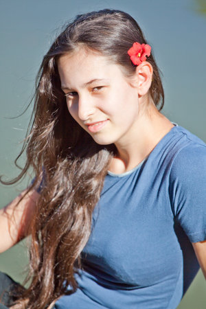 Portrait of a beautiful young woman spending a summer day outdoor.