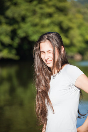 Portrait of a beautiful young brunette enjoying a day outdoor.