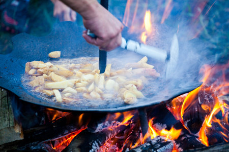 Traditional way of preparing potatoes on barbecue in Romania.の写真素材