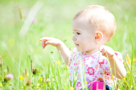 Baby girl spending time outdoor on a summer day.の写真素材