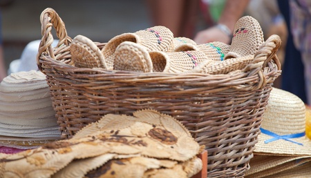 Handmade shoes for sale in a basket at a souvenir shop in Romania.の写真素材