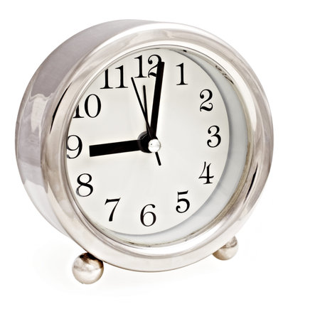 Silver modern clock showing 9 o
