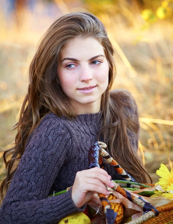 Portrait of a beautiful 20 year old young woman outdoor during autumn season.の写真素材