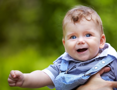 Portrait of a happy baby boy portrait outdoor in summer.の写真素材
