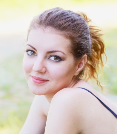 Portrait of a beautiful 20 year old woman enjoying a summer day outdoor.の写真素材