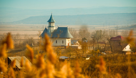 Landscape of the church in the small village of Stanca in Romania in the afternoon.の写真素材