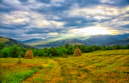 Picturesque landscape of the sunrise over Cernei Mountains seen from nearby Mehadia, Romania.の写真素材