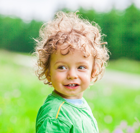 Portrait of 1 year old baby boy having fun on a mountain meadow.の写真素材