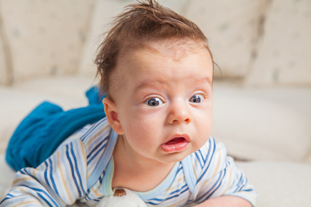 Cute 2 months old baby boy at home on the sofa.の写真素材
