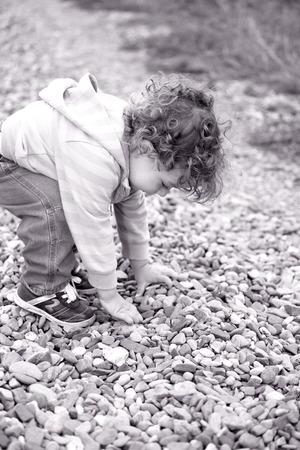 1 year old baby boy walking through the countryside.の写真素材