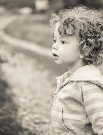 1 year old baby boy walking through the countryside.の写真素材