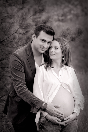 Pregnant woman with her husband relaxing outdoor.の写真素材