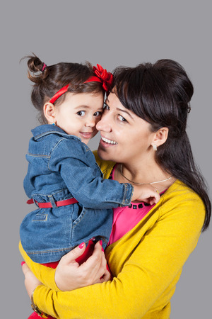 Mother with daughter, 18 months old, happy, studio shot.の写真素材