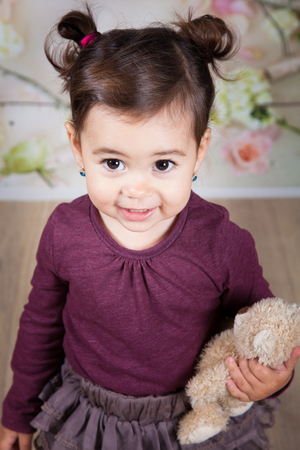 Portrait of 1 and a half gorgeous baby girl indoor.の写真素材