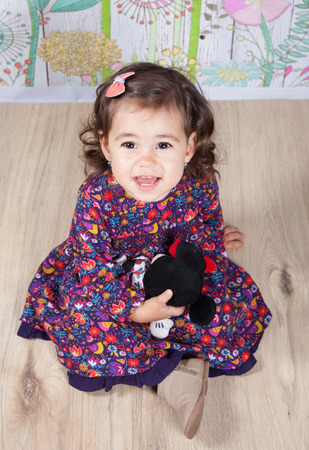 Portrait of 1 and a half gorgeous baby girl indoor.の写真素材