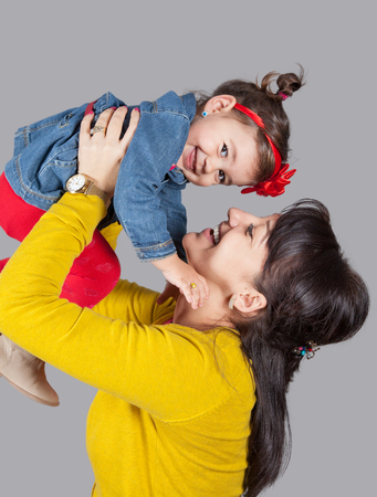 Mother with daughter, 18 months old, happy, studio shot.の写真素材