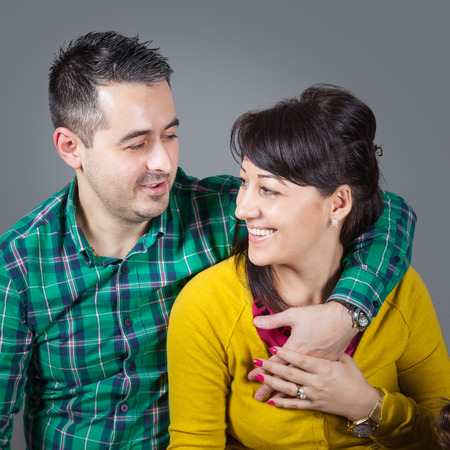 Happy young couple portrait in studio.の写真素材