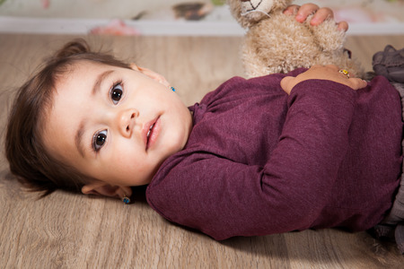 Portrait of 1 and a half gorgeous baby girl indoor.の写真素材