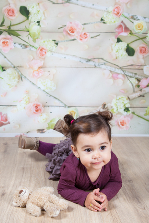 Portrait of 1 and a half gorgeous baby girl indoor.の写真素材