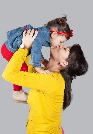 Mother with daughter, 18 months old, happy, studio shot.の写真素材