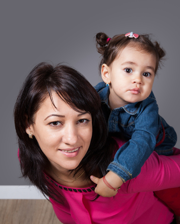 Mother with daughter, 18 months old, happy, studio shot.の写真素材
