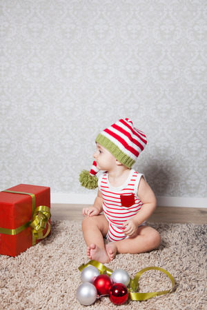 Portrait of 1 year old baby boy, Christmas theme, studio shot.の写真素材