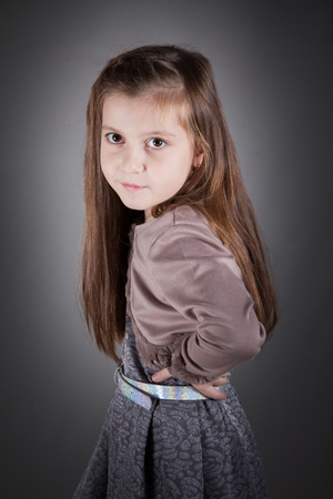 Portrait of a 8 year old girl, nicely dressed, studio shot.の写真素材