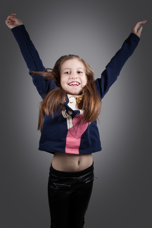 Portrait of a 8 year old girl, nicely dressed, studio shot.の写真素材