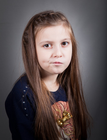 Portrait of a 8 year old girl, nicely dressed, studio shot.の写真素材