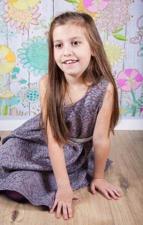 Portrait of a 8 year old girl, nicely dressed, studio shot.の写真素材