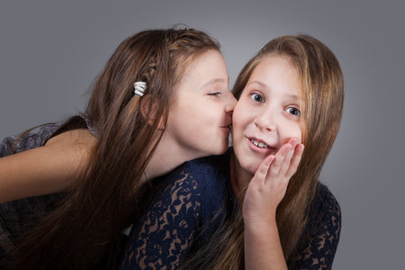 Portrait of8 and 10 year old sisters, studio shot.の写真素材