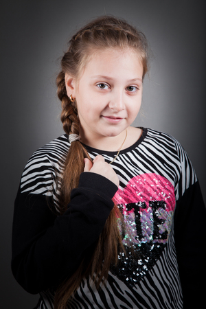 Portrait of a 10 year old girl, studio shot.の写真素材