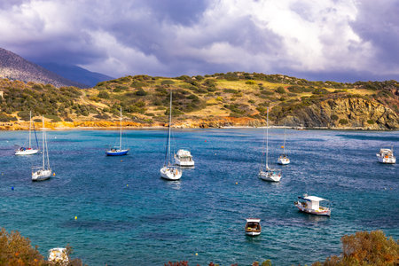 Scenic view of sea bay with boats and beach in background, in winter, in Anavyssos, Greece. Image taken from Agios Nikolaos Peninsula.の写真素材