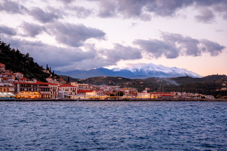 Sunset over Gytheio, during winter, in Laconia, Greece. The snowy peaks of Taigetos Mountains seen in the distance.の写真素材
