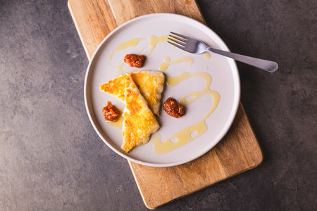 Fried cheese, saganaki. Cheese saganaki the famous Greek fried cheese with quince sauce.の写真素材