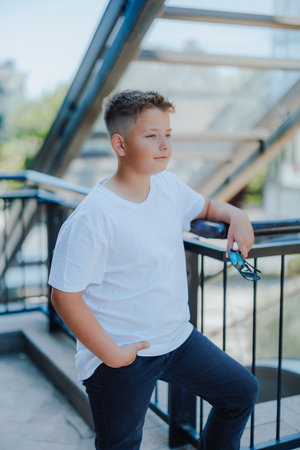 Urban portrait of a 10 year old boy in a city scenery.の写真素材