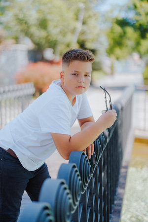 Urban portrait of a 10 year old boy in a city scenery.の写真素材