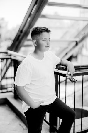 Urban portrait of a 10 year old boy in a city scenery.の写真素材