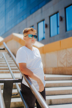 Urban portrait of a 10 year old boy in a city scenery.の写真素材