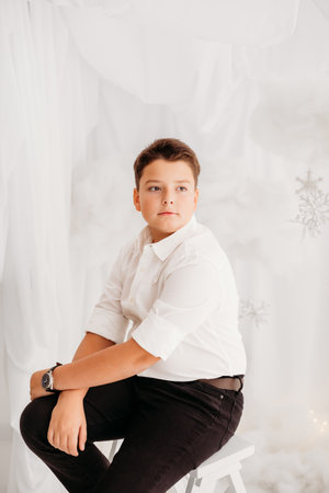 Studio portraits of 11 yeard preteen boy, in Christmas setting, dressed elegant.の写真素材