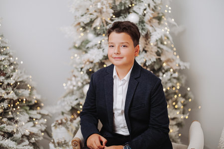 Studio portraits of 11 yeard preteen boy, in Christmas setting, dressed elegant.の写真素材