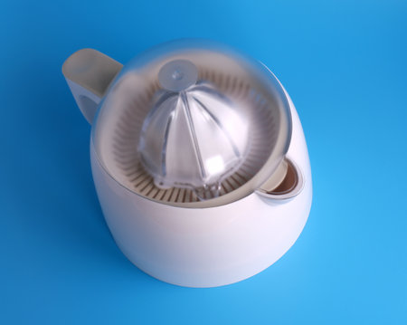 plastic juicer fruit on blue backgroundの写真素材