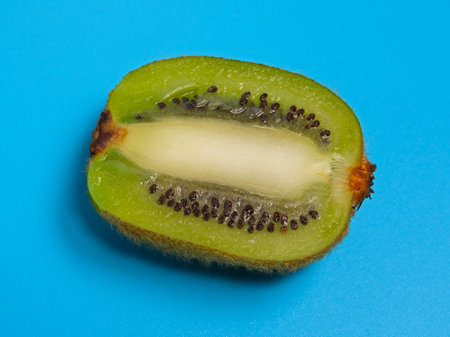 sliced kiwi fruit on blue backgroundの写真素材
