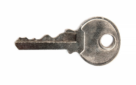 steel small key for padlock on white background