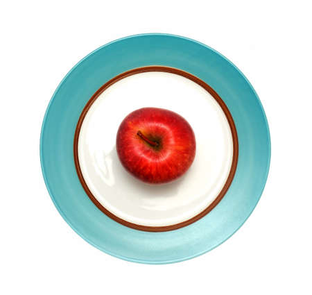fresh red apple fruit in plate isolated on white backgroundの写真素材