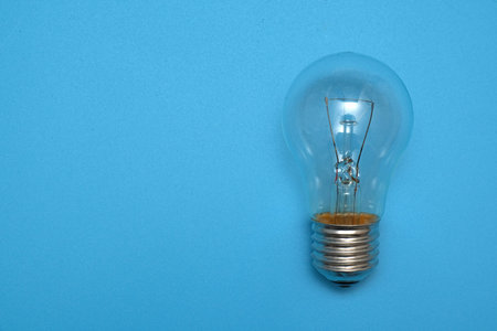 classic electric light bulb object on blue background