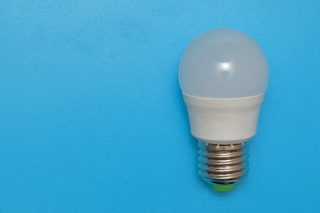 light bulb electric lamp on blue background