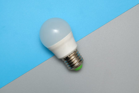 light bulb electric lamp on blue backgroundの写真素材